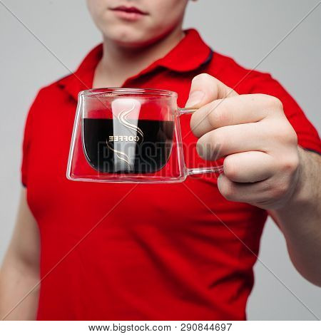 Close Up Of Young Man Hand Holding Creative Transparent Cup.