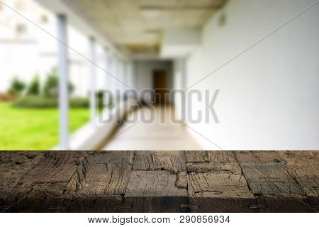 Wooden Brown Table Top Against The Blurred Corridor, Passage And Courtyard Of The House .for Product