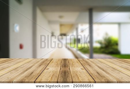 Wooden Brown Table Top Against The Blurred Corridor, Passage And Courtyard Of The House .for Product