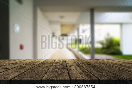 Wooden Brown Table Top Against The Blurred Corridor, Passage And Courtyard Of The House .for Product