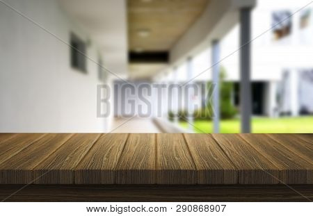 Wooden Brown Table Top Against The Blurred Corridor, Passage And Courtyard Of The House .for Product