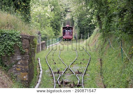 The View Of Red Funicular And Railroad Through Green Trees Between Montecatini Terme And Montecatini