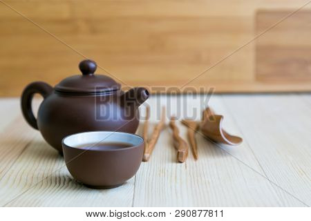 Dishes For Tea And Wooden Sticks On A Light Background. A Set Accessories For The Tea Ceremony.
