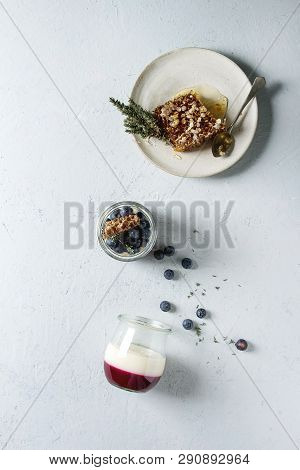 Homemade Classic Dessert Panna Cotta With Blueberry Berries In Jars, Decorated By Mint, Thym, Honey 