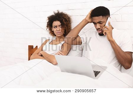 I Cant Stand When Hes Working All The Time. African-american Guy Working With Laptop And Talking On 