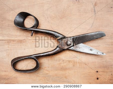 Old Steel Scisors On A Wooden Table