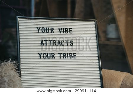 Your Vibe Attracts Your Tribe Motivational Quote On A White Letter Board.