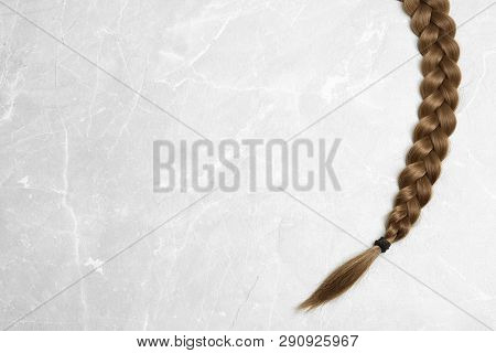 Braided Hair On Grey Background, Top View With Space For Text