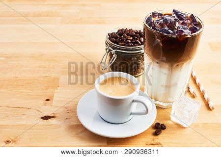Cup Of Coffee Or Espresso, Iced Coffee And Latte Macchiato In Tall Glass With Straws On Wooden Table