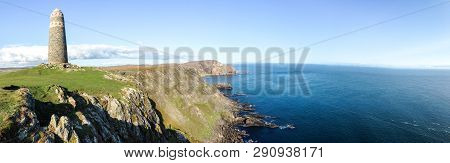 A Large Rock Tower Sits On A Grassy Field At The Tip Of The Oa Peninsula On The Island Of Islay In S