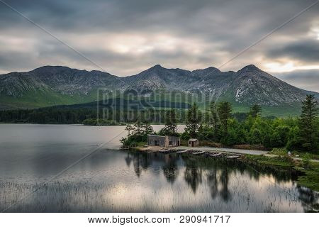 Beautiful Lake Called Lough Inagh In County Galway, Ireland With A Cabin And Boats At The Lake Shore