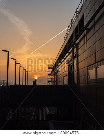 Germany, Berlin, February, 27-2019, A Pedestrian In A Beautiful Sunrise At The Train Station Warscha