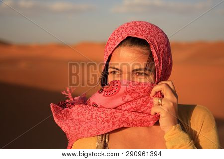 White Girl Hiding Her Mouth Evidencing Her Eyes And Forehead Using A Pink Scarf And An Yellow Blouse