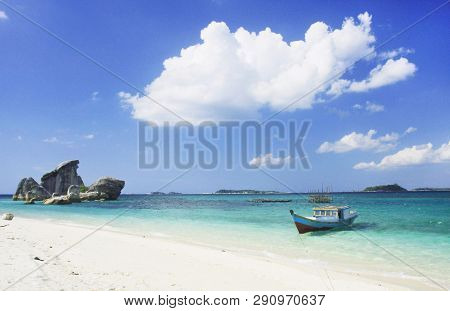 A Boat On The Beach  Of  Belitung Island In Bright Blue  Sky