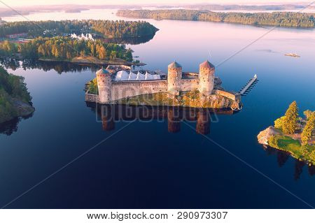 The Medieval Fortress Of Olavinlinna In The Morning Landscape (aerial Photography). Savonlinna, Finl