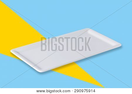 Empty White Cornered Plate On Blue Yellow Popart Background, Front View, Oblique Position