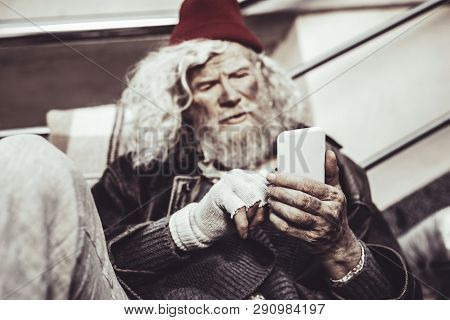 Concentrated Caucasian Almsman Typing Message To His Friend.
