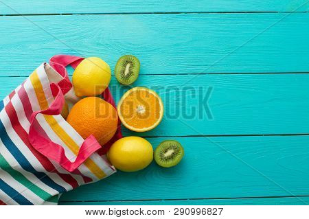 Summer Fun Time And Fruits On Blue Wooden Background. Mock Up And Picturesque. Orange, Lemon, Kiwi F