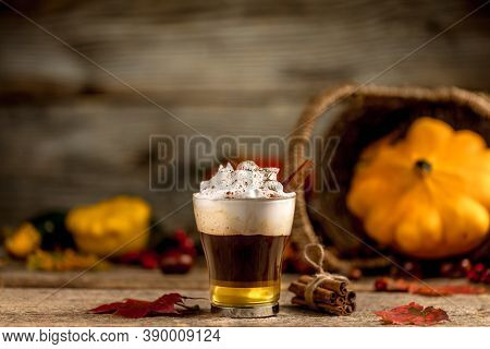 Pumpkin Latte With Cinamon Powder And Delicious Flavours On The Old Textured Wood Table With Colorfu