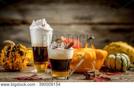 Pumpkin Latte With Cinamon Powder And Delicious Flavours On The Old Textured Wood Table With Colorfu