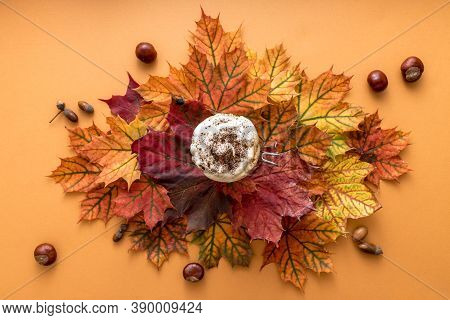 Cozy Autumn Style Flat Lay Of Hot Pumpkin Latte With Whipped Milk Cream, Cinamon And Colorful Dry Le