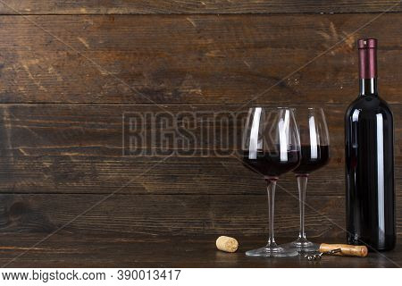 Bottle Of Wine And Two Glasses. There Is A Corkscrew And A Cork Nearby. Soace For Text.