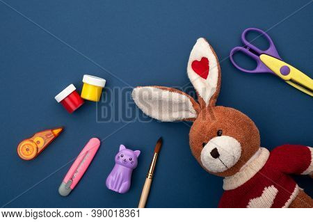 The School Office Lies On A Blue Background, Next To A Plush Bunny