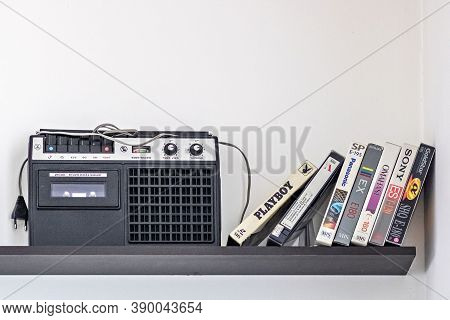 Vintage Cassette Recorder And Videotapes On The Shelf