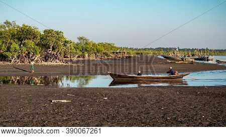 Chaung Thar, Myanmar - December 26, 2019: People In Traditional Wooden Fishing Boats By The Coast Du