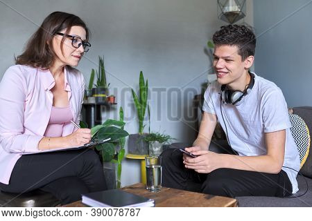 Boy Teenager Gives Interview To Woman Psychologist In Office, College Student At Consultation. Adole