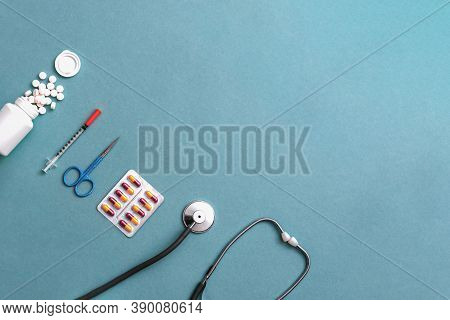 Pills, Ampoule, Syringes, Capsules, Stethoscope On The Blue Doctor S Table. Copy Space. Place For Te