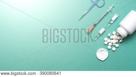 Pills, Ampoule, Syringes, Capsules, Stethoscope On The Green Doctor S Table. Copy Space. Place For T