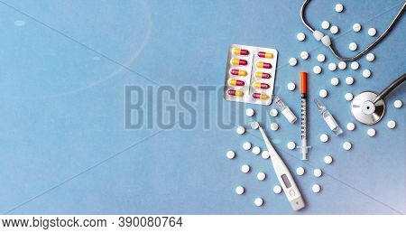 Pills, Ampoule, Syringes, Capsules, Stethoscope On The Blue Doctor S Table. Copy Space. Place For Te