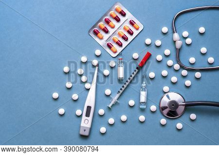 Pills, Ampoule, Syringes, Capsules, Stethoscope On The Blue Doctor S Table.