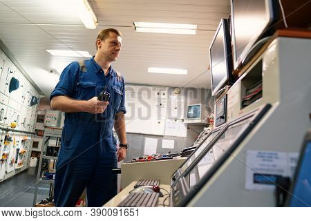 Marine Engineer Working On Radio Communication At Engine Control Room Ecr