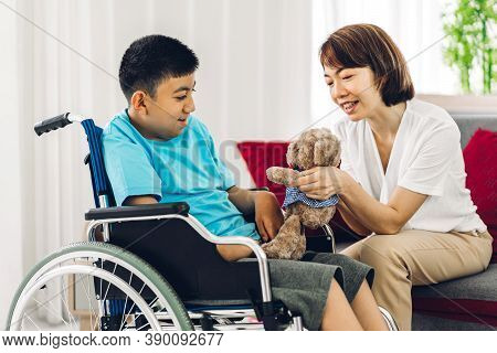 Portrait Of Enjoy Happy Love Family Asian Mother Playing And Carer Helping Look At Disabled Son Chil