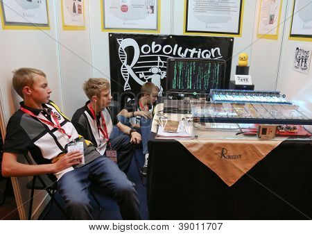 SUBANG JAYA - NOV 10: Unidentified students from South Africa shows a musical robot made to help children with learning disability at the World Robot Olympaid on Nov 10, 2012 in Subang Jaya, Malaysia.