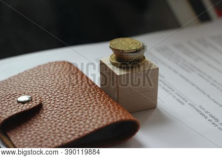 Brown Leather Wallet And Stack Of Bronze Coins Put On Wooden Cube. Little Money Or Powerty Concept. 