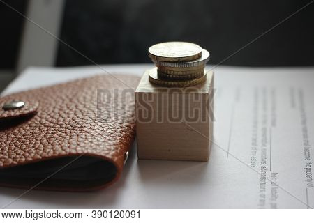 Brown Leather Wallet And Stack Of Bronze Coins Put On Wooden Cube. Little Money Or Powerty Concept. 