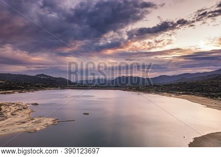 Aerial View  Of Dawn Breaking Over The Lac De Codole And Distant Mountains In The Balagne Region Of 