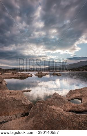 Wide Angle Image Of Dawn Breaking Over The Lac De Codole And Distant Mountains In The Balagne Region