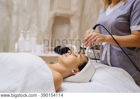 Lateral View Of Woman Facial Massage Spa Procedure. Electric Stimulation Facial Skin Care. Microcurr