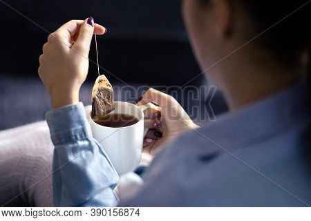 Woman Holding Tea Bag In Cup To Make A Healthy Hot Beverage In Winter. Something Warm For The Cold S
