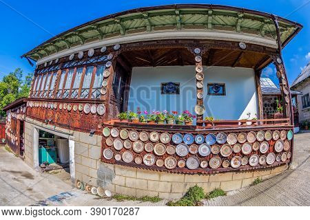 Romanian Traditional Ceramic Plates From Horezu Area, Romania, Placed Ornamentally On A Rustic Woode