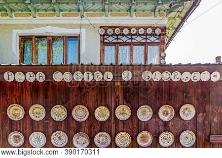 Horezu-olari, Romania - July 23, 2020: Romanian Traditional Ceramic Plates Placed Ornamentally On A 