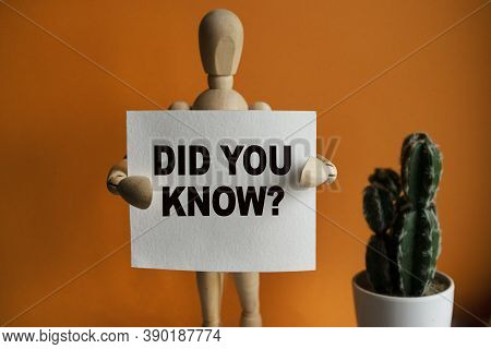 The Wooden Man Holds A White Sign With The Text Did You Know In His Hands. The Content Of The Letter