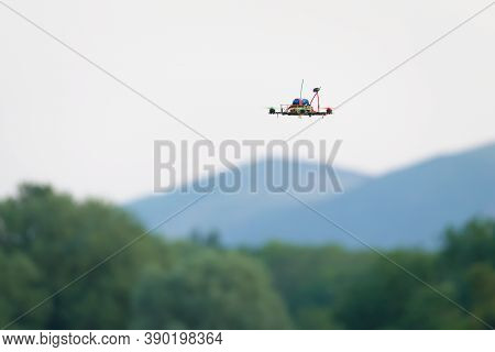 Small Home Made Fpv Racing Quad Copter Camera Drone Flies In Front Of The Malvern Hills And Trees. S