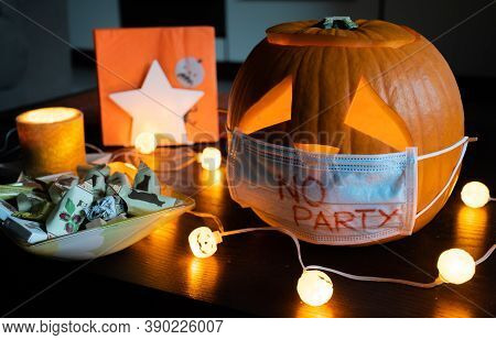 New York, Usa - October 17 2020: Carved Halloween Pumpkin With Sad Eyes Wearing Mask, No Party Durin