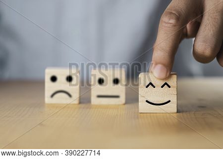 Select Emotion Or Mood Concept , Hand Holding Smile Face  Or Happy Face Which Print Screen On Wooden