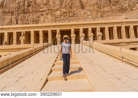 A Young Woman On The Entrance Stairs To The Funerary Temple Of Hatshepsut In Luxor. Egypt